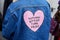 Woman with blue jeans jacket with pink heart with `Nothing better than pizza` motto before fashion Albino