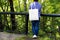 Woman in blue jumper holding tote bag mockup