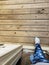 Woman in blue leggings and blue ankle socks stepping out of a door onto a wood porch