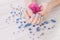 Woman with blue manicure holds flowers