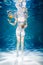 Woman on blue with no face with vegetables underwater, woman healthy eating concept