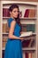 Woman in blue open back dress with lace reading book. Romantic