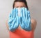 Woman with blue rubber glove make stop gesture