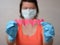 Woman in blue rubber gloves take paper hearts