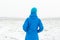 Woman in blue standing in a snowy field