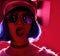 Woman in blue wig street style fashion lick oneself wearing gold hat cap and round sunglasses in red pink neon light