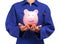 Woman in blue work uniform holding a piggy bank
