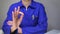 Woman in blue work uniform making the Okay sign