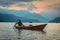 Woman on a boat at lake at sunset, Pokhara, Nepal