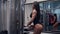 woman bodybuilder is lifting weights on sport equipment in gym, professional training