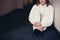 Woman in boiler suit sitting in corridor