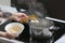 Woman boiling rice in kitchen