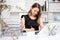 Woman bookkeeper writing on paper in office