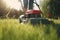 woman in boots and protective workwear cutting the grass with a riding lawnmower on a sunny day