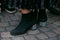 Woman with boots with silver glitter heel and black velvet pleated skirt before Antonio Marras fashion show