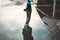 A woman in boots stands near the puddles. Reflections of the sky in puddles. Lower angle. The concept of psychology and loneliness