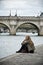 woman in border Seine river near new bridge (pont neuf)