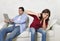 Woman bored and frustrated ignored while internet addict husband or boyfriend using digital tablet networking