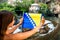 Woman with Bosnian flag in Blagaj village