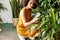 Woman botanist sitting observing plant