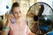 Woman with bottle of water enjoying breeze in the front of fan