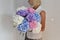 Woman with bouquet of hydrangeas. Beautiful fresh delicate flowers for holiday. Woman with beautiful flowers in her hands