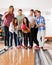 Woman Bowling While Friends Cheering