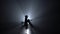 Woman bows the cello in a smoky room at night. Silhouette. Black smoke background