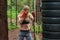 Woman boxer professional fighter posing in boxing stance, working out outdoors.