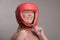 Woman boxer wearing a red head guard