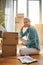 Woman, boxes and portrait with document on the floor with a smile at a new home for investment. Property, box and