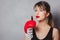 Woman in boxing gloves with red lipstick in hands