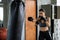 woman boxing train by punching bag