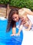 Woman and boy by the pool side