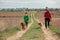 Woman and boy in the street wearing protective mask and walking with dogs. corona virus concept. Family walking dog during virus