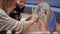 Woman with boy write on cardboard of funny fish at table