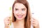 Woman with braces holding electric and traditional toothbrush