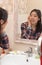 Woman with braces looks in bathroom mirror, touching and checking face, daily hygiene and cleansing, female skincare