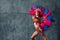 Woman in brazilian samba carnival costume with colorful feathers plumage