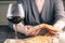 Woman break bread and drinking red wine