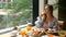 Woman on breakfast near window, eat fresh bakery in restaurant in luxury hotel