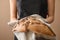 Woman breaking fresh tasty bread, closeup