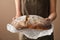 Woman breaking fresh tasty bread, closeup