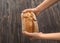 Woman breaking fresh tasty bread on wooden background