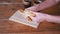 Woman Breaks Fresh Crispy Pastries with Her Hands over the Table. Close-up.