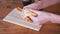 Woman Breaks Fresh Crispy Pastries with Her Hands over the Table. Close-up.