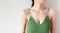 Woman is Breast in Green Underwear Posing on Grey Background,Show the Bra. Cropped Close Up of Sexy Female Wearing Sport Bra