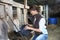 Woman breeder feeding farm animals in barn