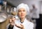 Woman brewer showing malted grain for craft beer production