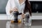 Woman brewing black tea in teapot at kitchen